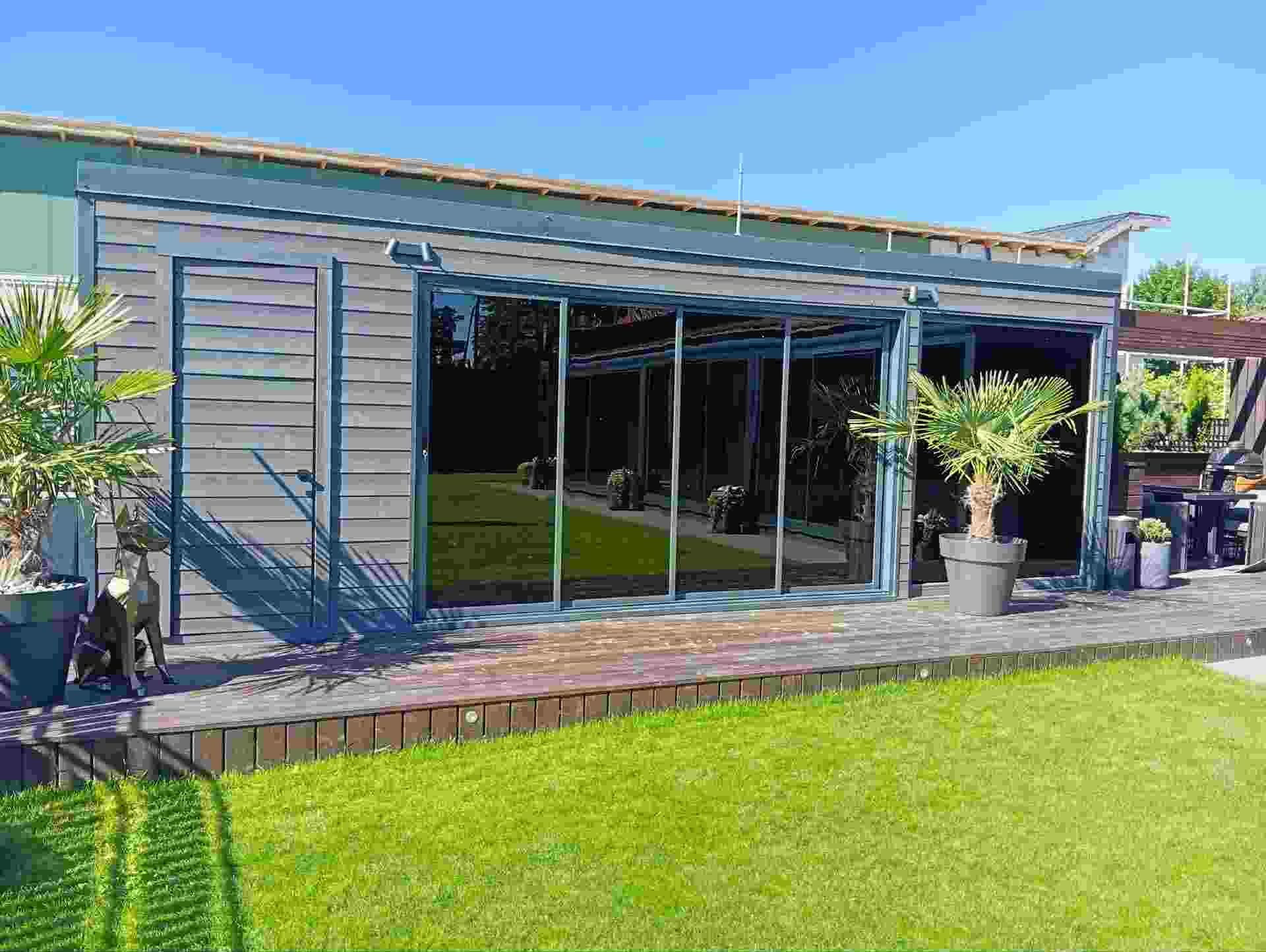 Photorealistic close-up render of a modern wooden terrace with louver privacy walls and pergola